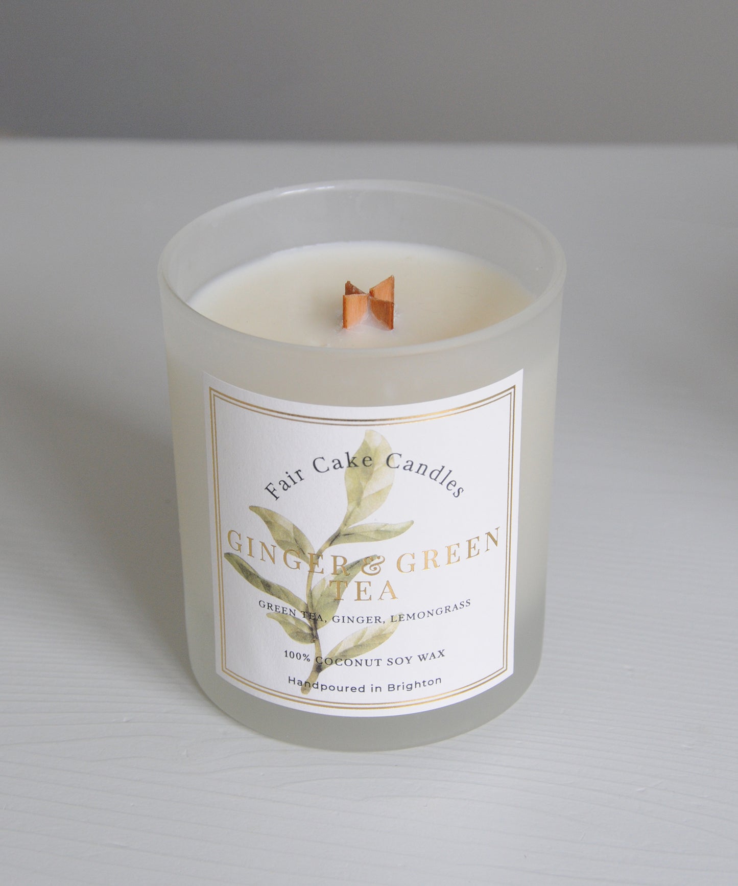 Frosted candle with a label on a gray background