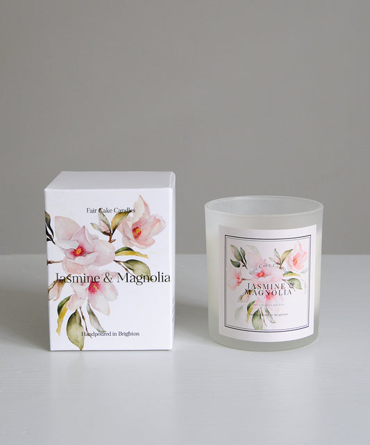 Fragranced candle and packaging with floral design on a gray background