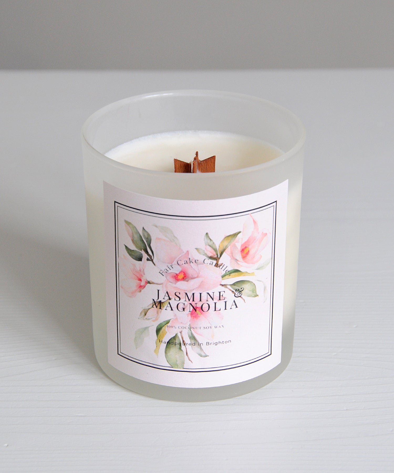 Candle with a floral label on a white background