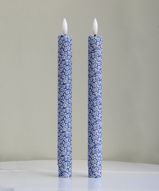 Two blue floral-patterned candles 