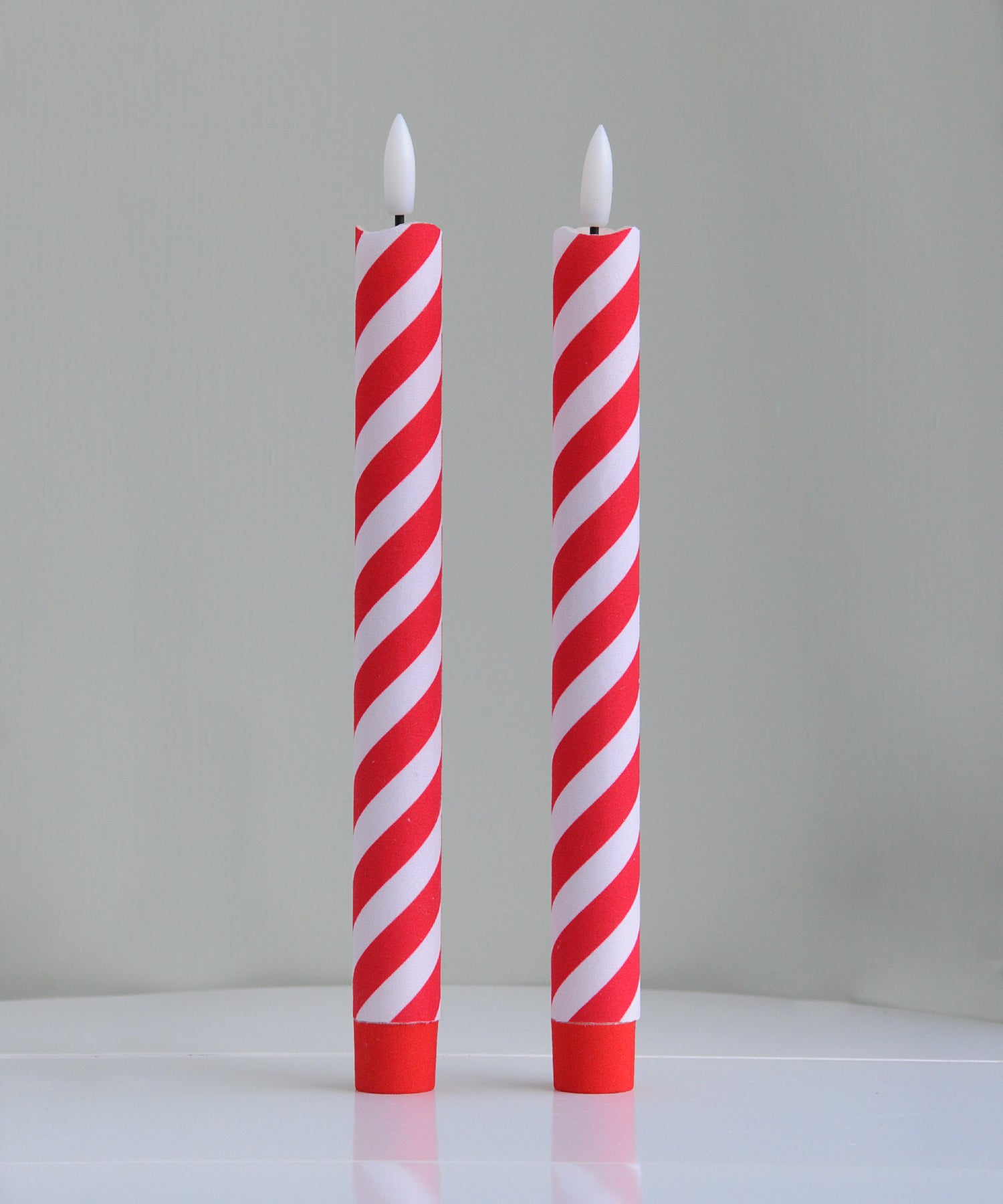 Two red and white striped candles 